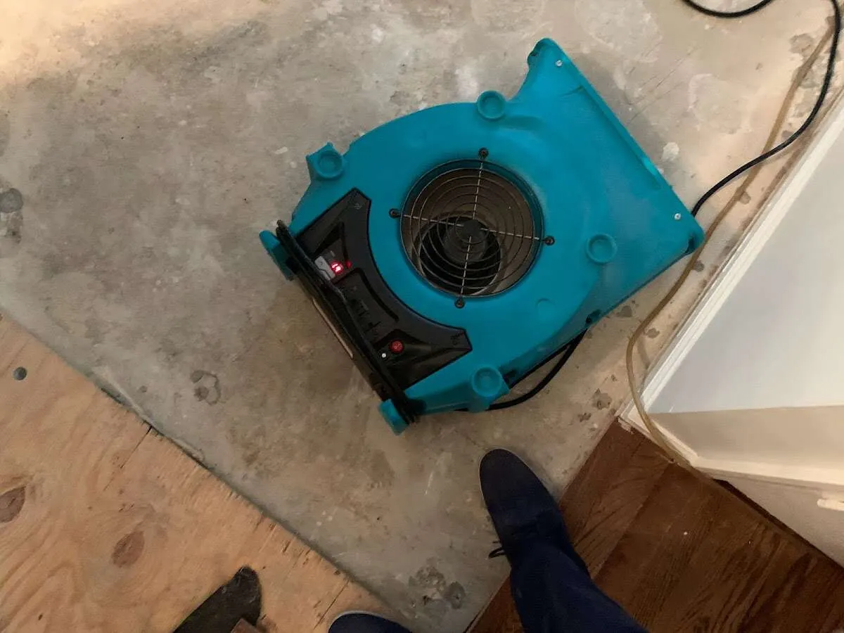 Air mover drying subfloor during Leak Detection & Repair in Lapeer